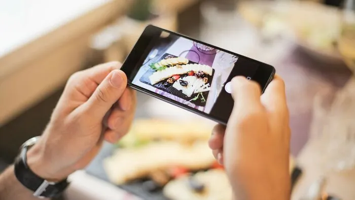When your food arrives, your date spends five minutes meticulously arranging the table lighting and plates for a photo. They ask you to hold your phone flashlight at a specific angle to get the perfect shot for their story. They take a great photo of the food and post it on their Instagram story.