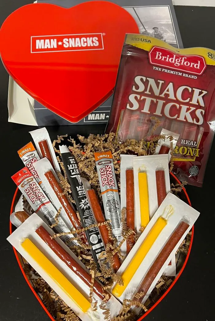 A heart-shaped box filled with various snack sticks and cheeses, perfect as a last minute Fathers Day gift.