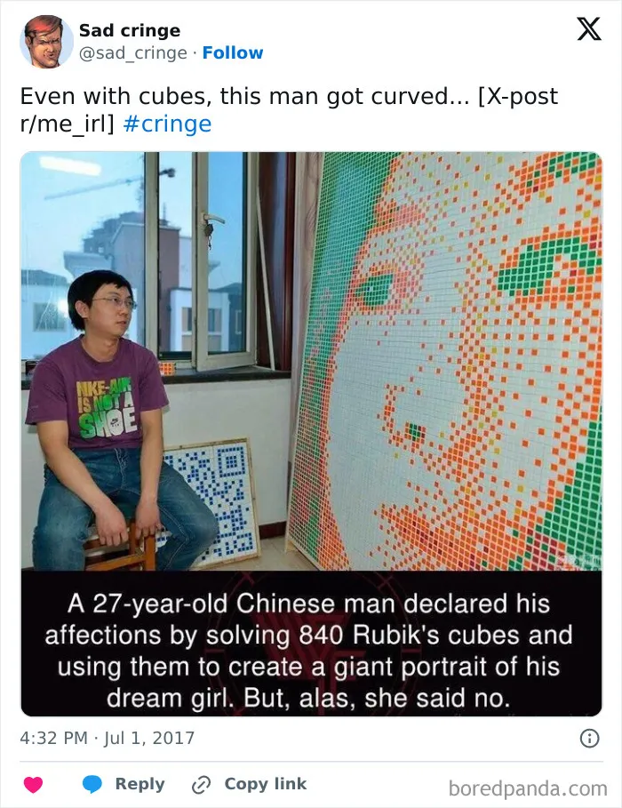A man next to a large Rubiks cube mosaic. This cringy effort to win over a girl was incredibly sad as she said no.