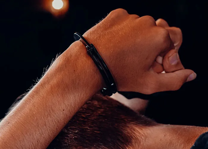 Close-up of hands bound by handcuffs symbolizing criminal restraint