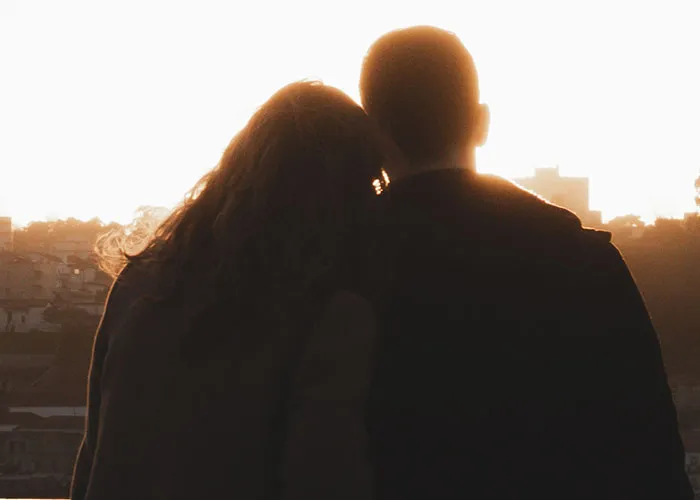 Silhouette of couple at sunset contemplating killers