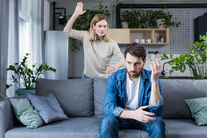 Couple arguing on couch in tense relationship moment