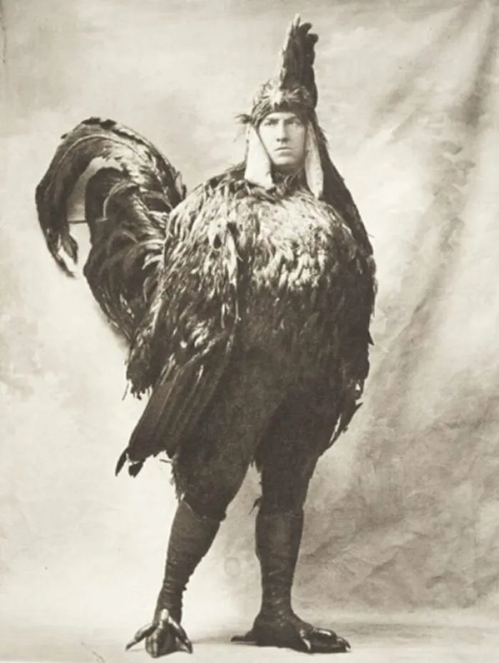 A person in a large, vintage rooster costume, one of many intact objects from the past.