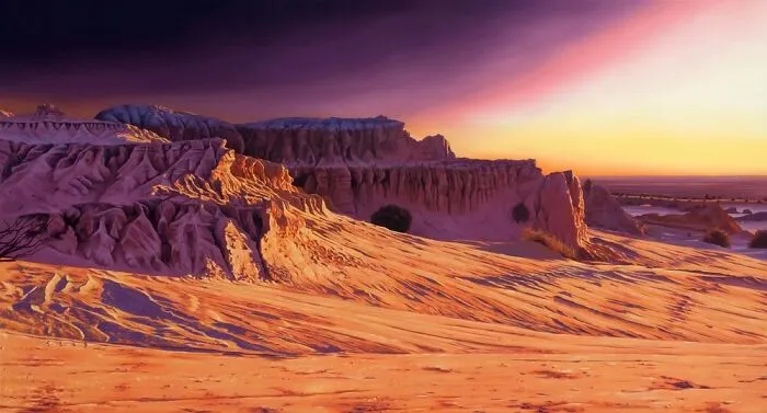 Artist paints desert landscape in vivid dreamlike colors.