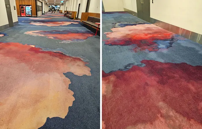 Carpet design fail with stain-like patterns that look like spills in hallway
