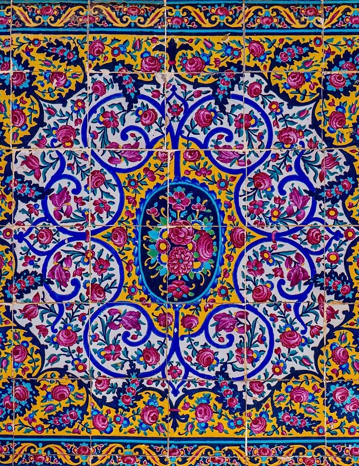 Close-up of classical Persian tile floral motifs with bold colors and detailed geometric patterns