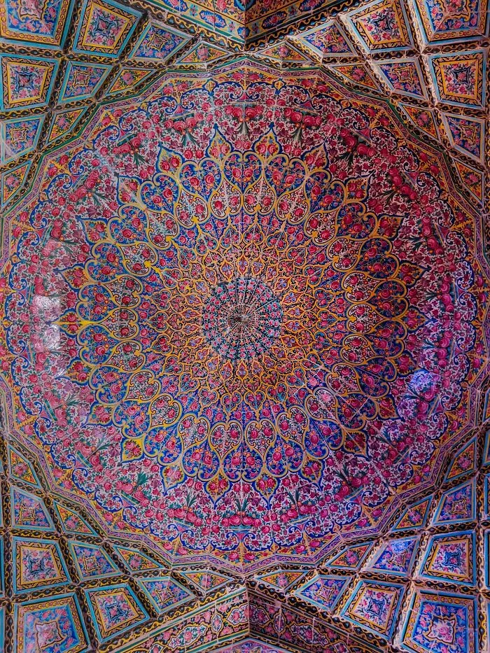 Ornate Persian dome ceiling with symmetrical floral and geometric pattern tiles