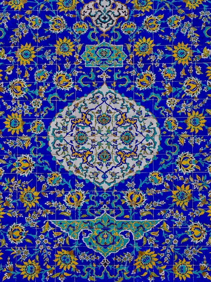 Persian floral and geometric tilework in rich blue and yellow colors
