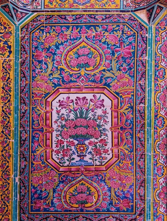 Intricate floral patterns on vibrant classical Persian tiles with rich colors and geometric borders
