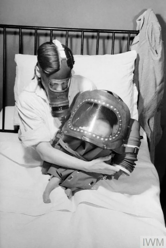 Air Raid Precautions On The British Home Front: Mother And Baby In Gas Masks, C 1941