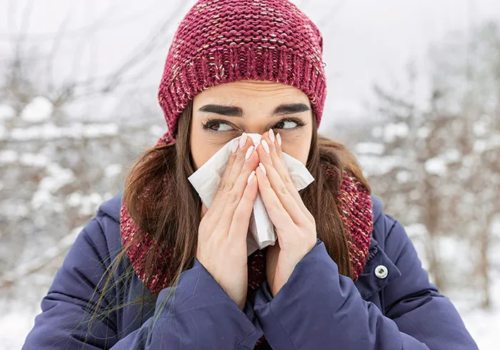 Woman in winter blowing nose with tissue cool facts