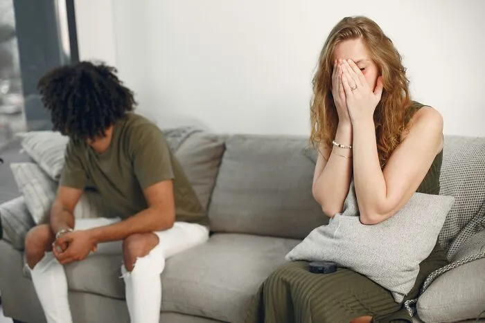 Upset couple ignoring each other after verbal fight illustrating savage women verbal weapons
