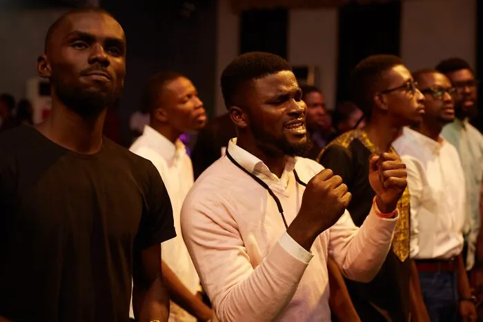 Men passionately singing, capturing wild coincidences that happened to people.