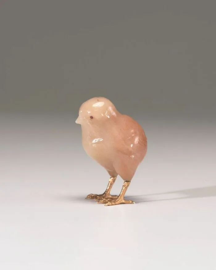 A tiny, carved chick with gold feet, one of the interesting objects that are still intact after all these years.