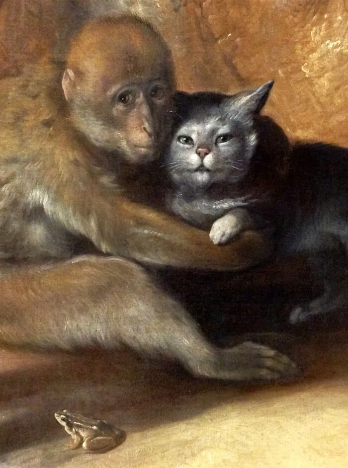 An old painting of a monkey embracing a cat, showcasing interesting intact photos and objects.