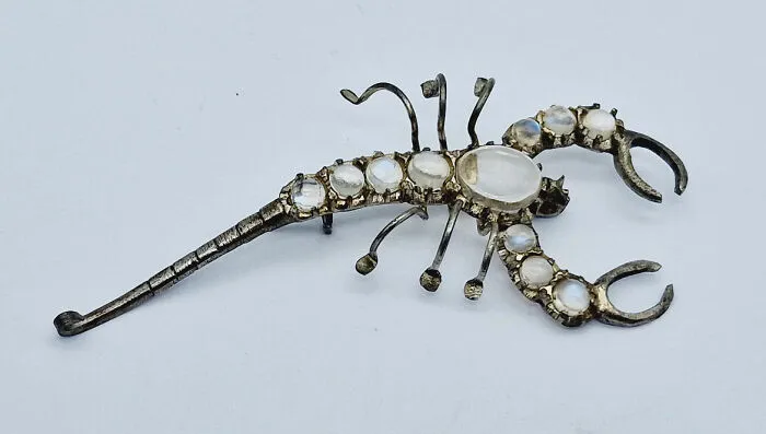 Scorpion-shaped brooch with moonstones, still intact after many years.