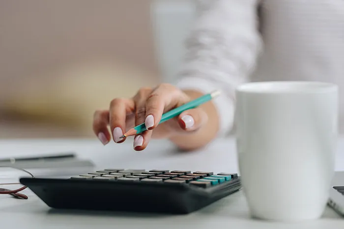 Hand using calculator representing smooth criminals planning
