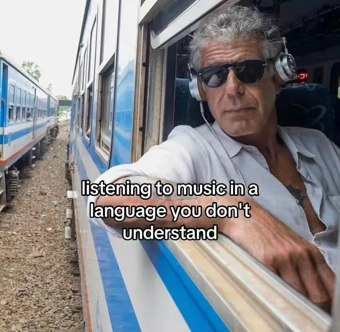 Funny post about a man on a train listening to music in an unknown language, relatable to funny posts about being a woman.