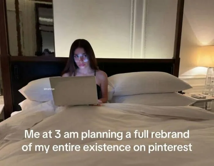 A woman working on a laptop in bed at 3 am, representing funny posts about being a woman.