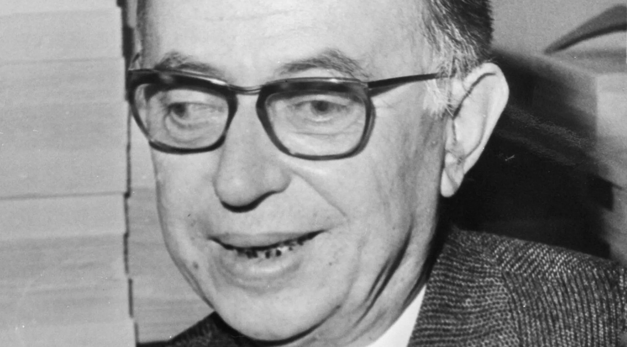 A black and white image of Jean-Paul Sartre, wearing glasses, as part of a general knowledge quiz.