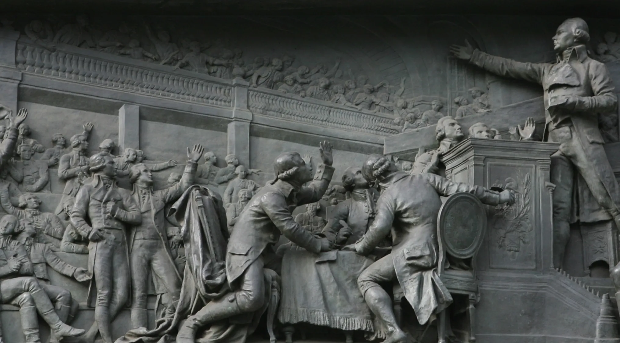 A detailed bas-relief sculpture depicting the violent collapse of the French monarchy during the French Revolution, 1789.
