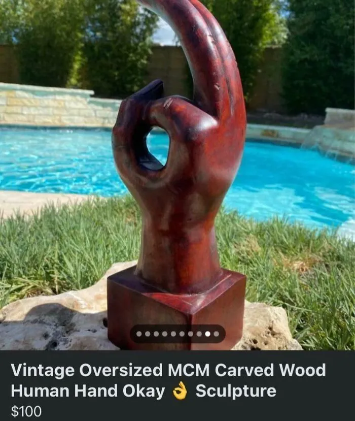 An oversized MCM carved wood human hand making an okay gesture, a quirky marketplace listing.