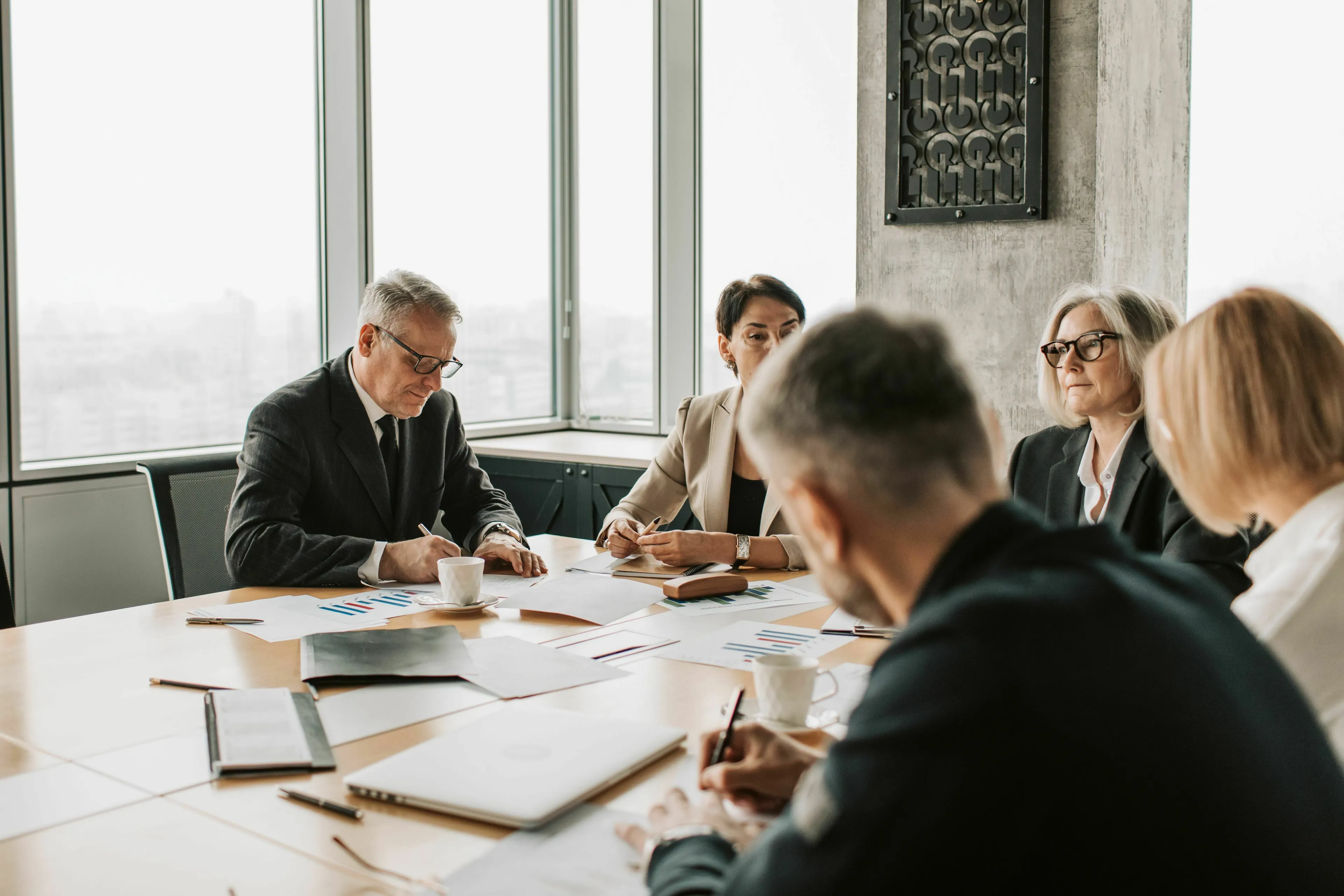 A group of diverse businesspeople in a modern office discussing a risky new project idea at a meeting.