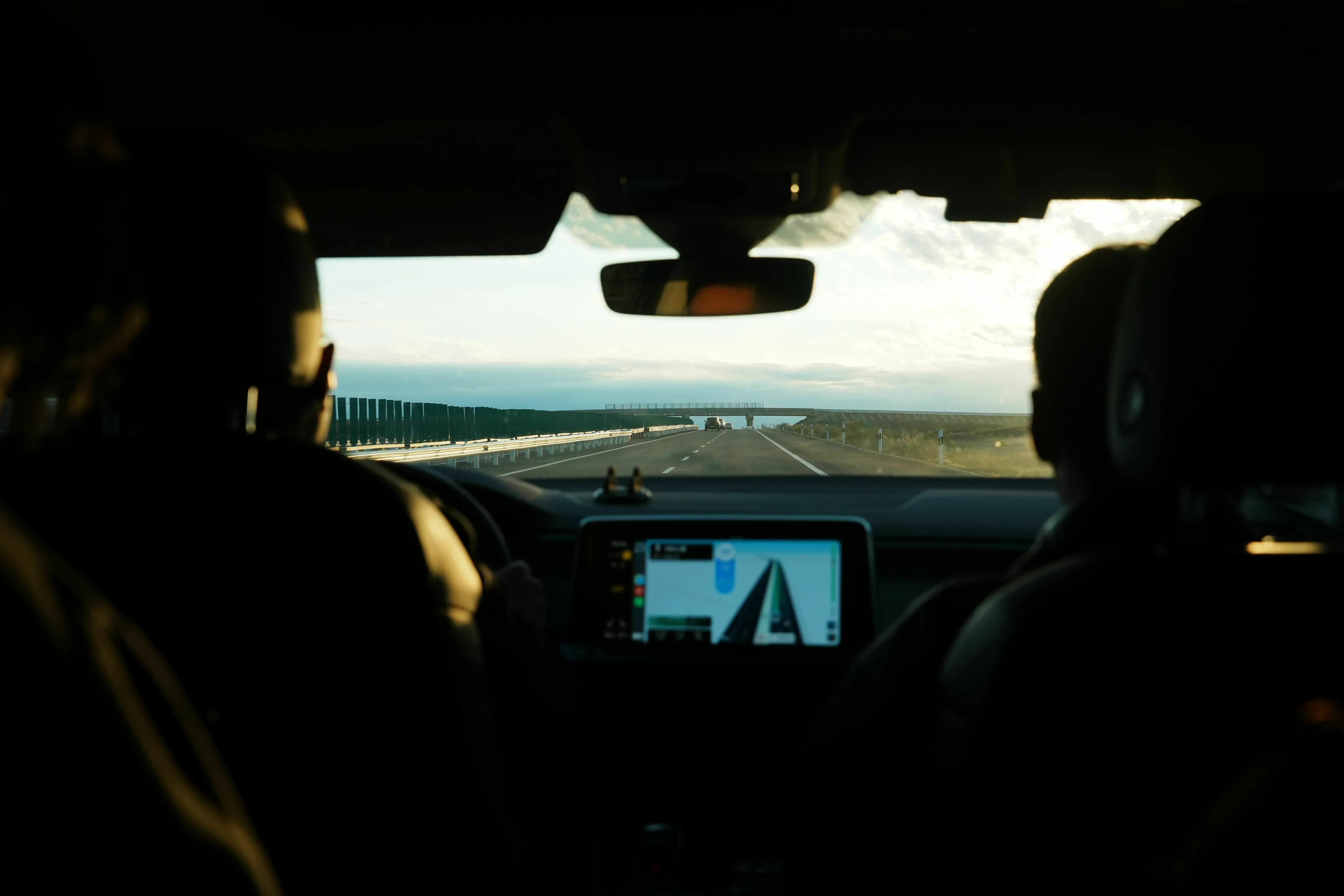 View from the back seat of a car on a road trip, with the GPS on, reflecting on risk taking.