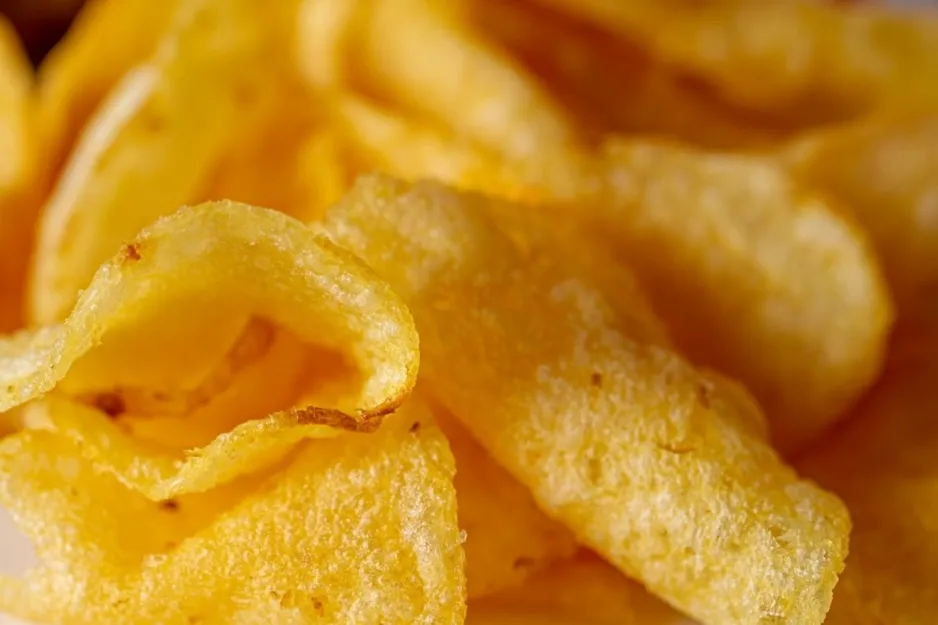 A close-up of crispy, golden potato chips, perfect for a road trip snack.