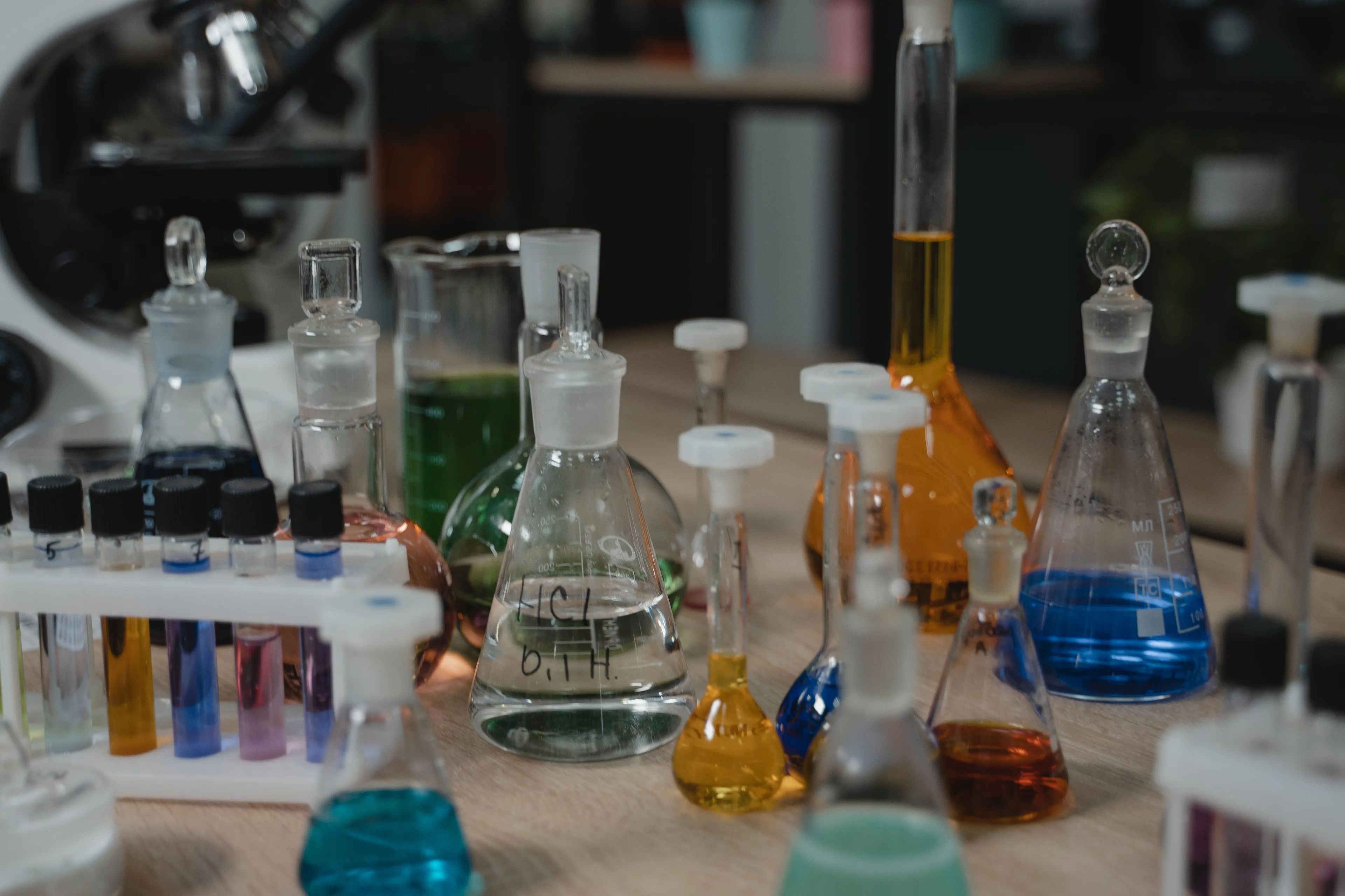 Various beakers and test tubes filled with colorful liquids, essential for a science subject.