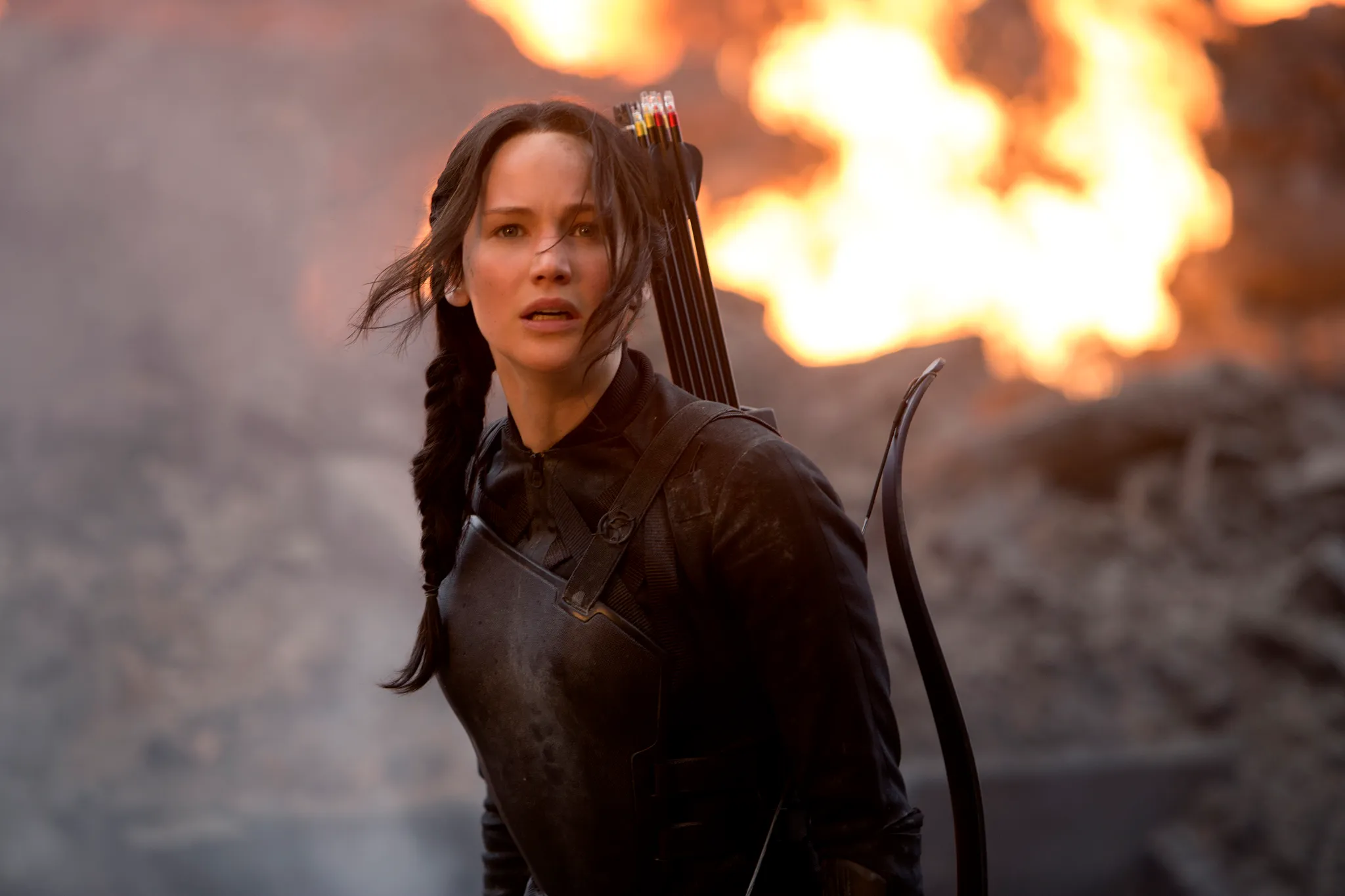 Katniss Everdeen with a bow and arrow, a fierce figure you would want by your side to take a risk.