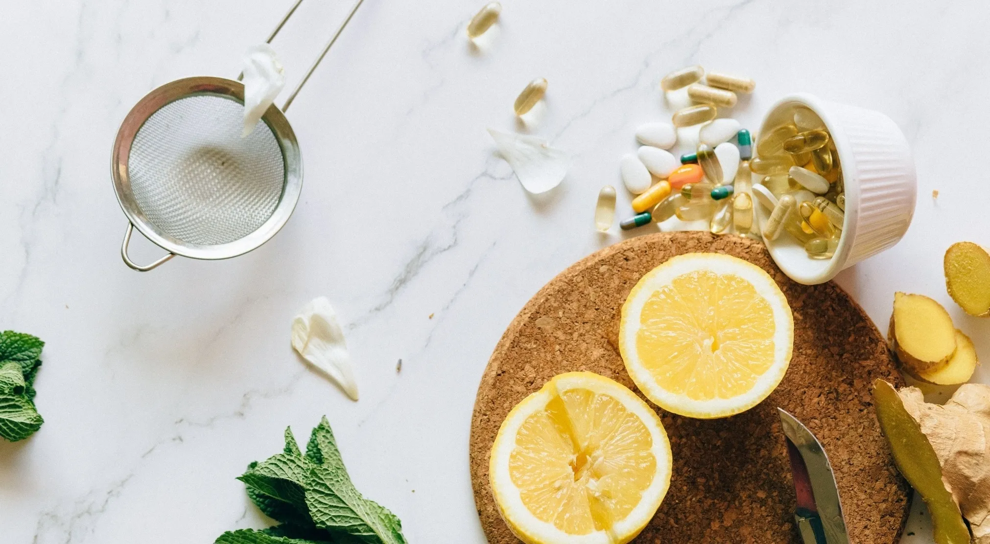 Natural ingredients, supplements, and a sieve on a marble surface. Boost your human body immune system.