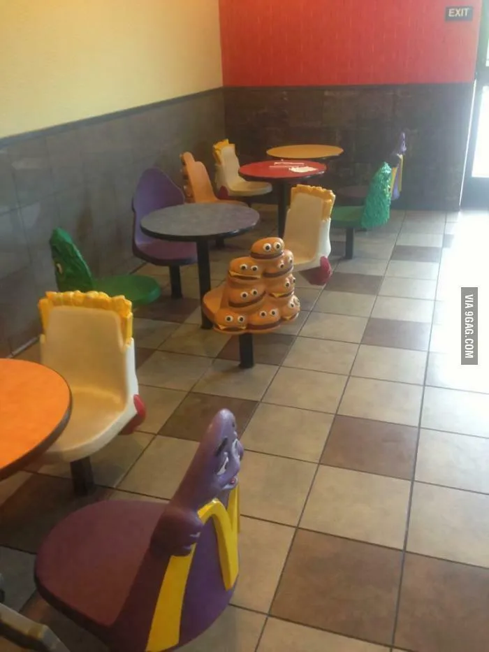 An empty McDonald's with themed tables and chairs, a throwback meme for 90s kids.