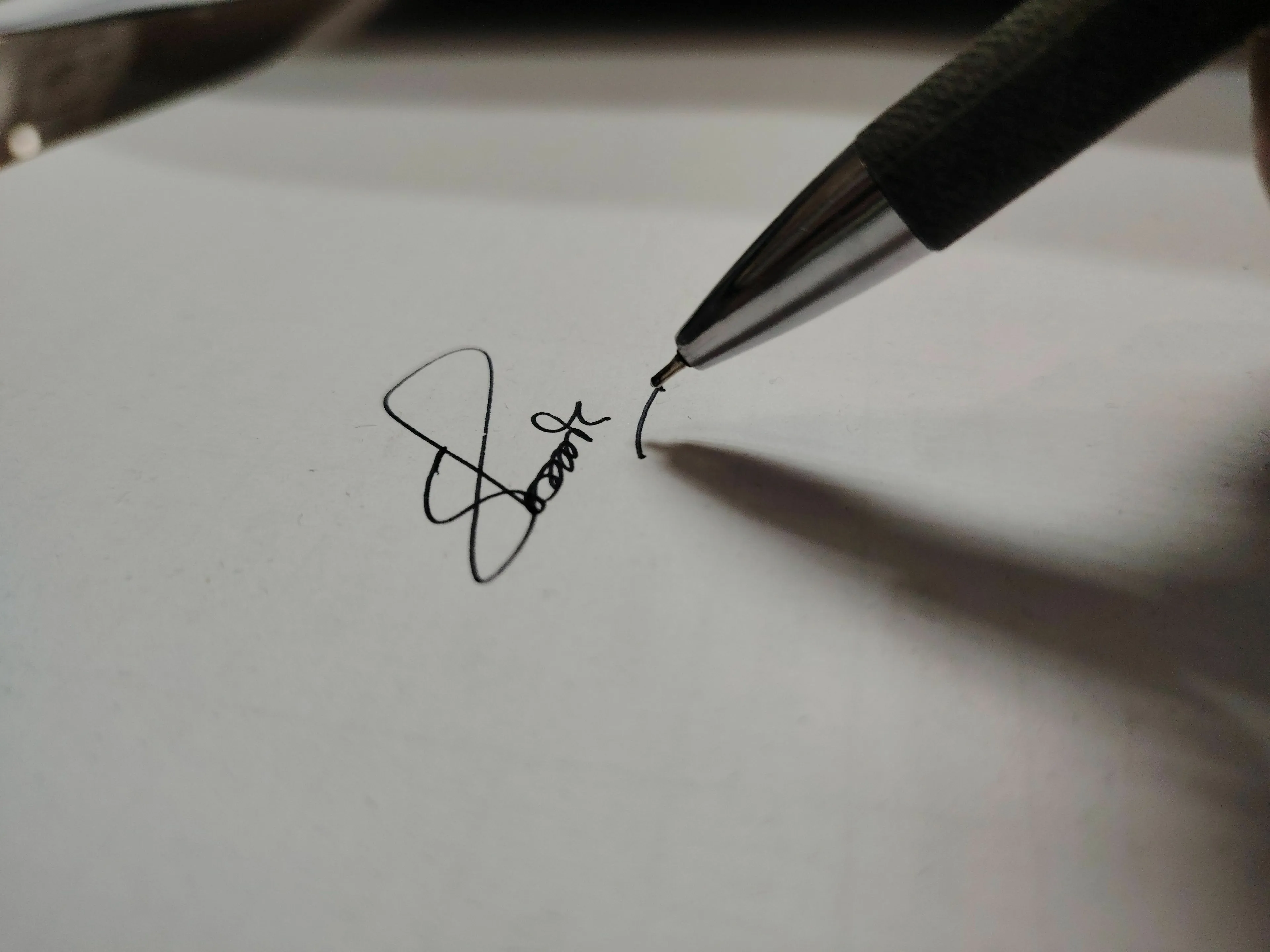 A pen signing a document, symbolizing a signature on a declaration.
