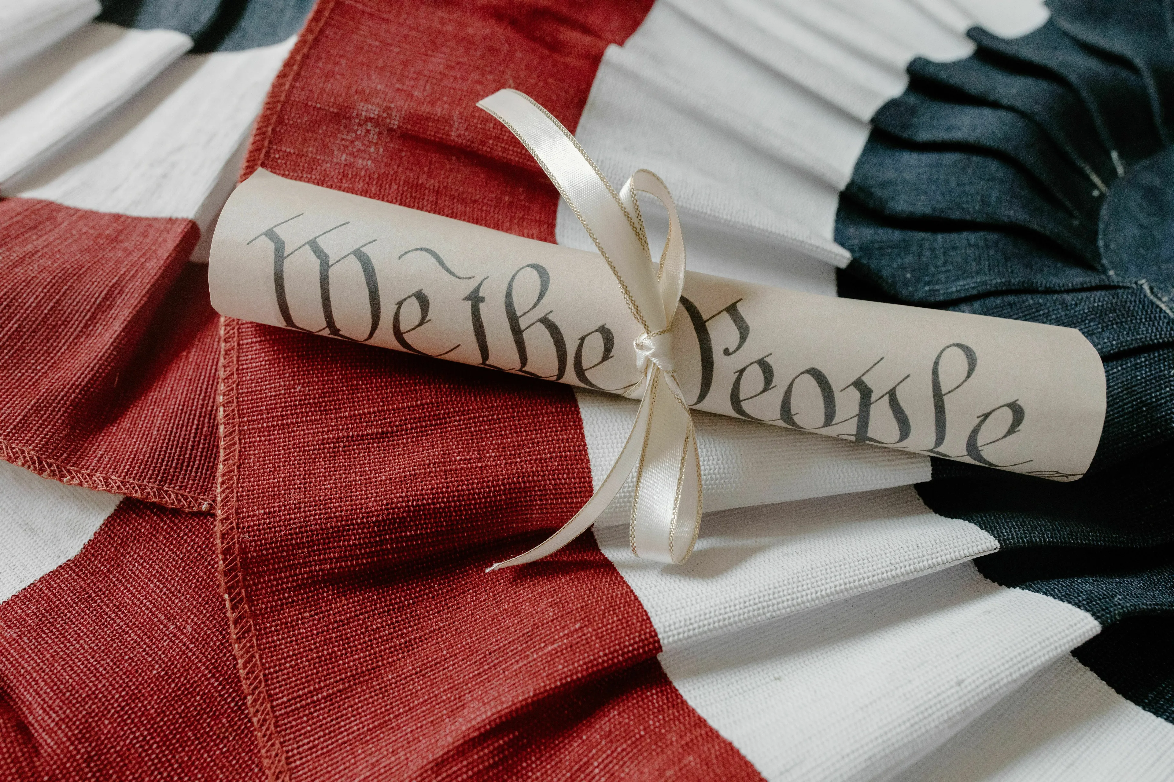 A rolled-up historical document tied with a ribbon, symbolizing the Declaration of Independence author.