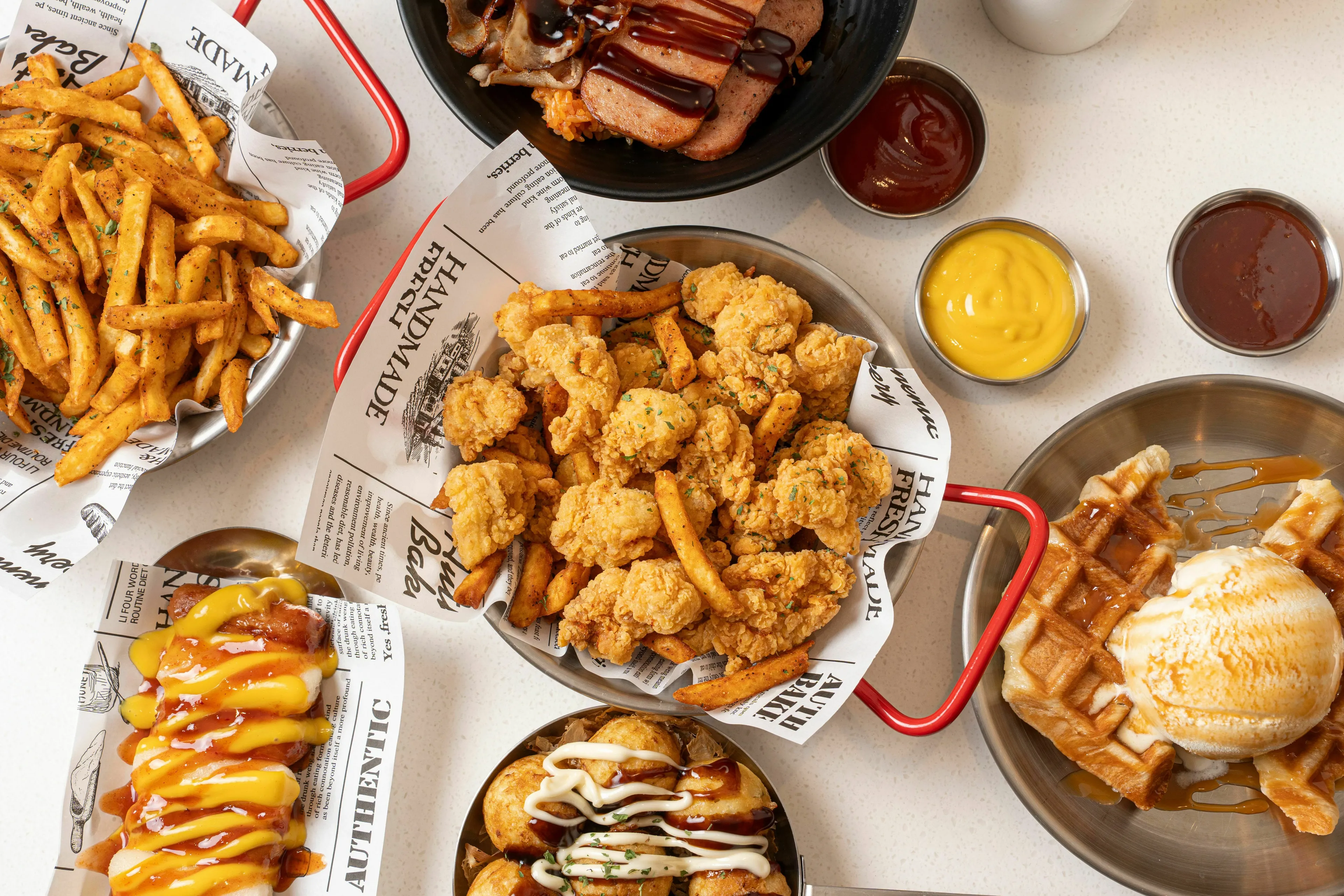 A spread of American fast food, including crispy fried chicken, golden fries, and sweet waffles, for a Fourth of July celebration.