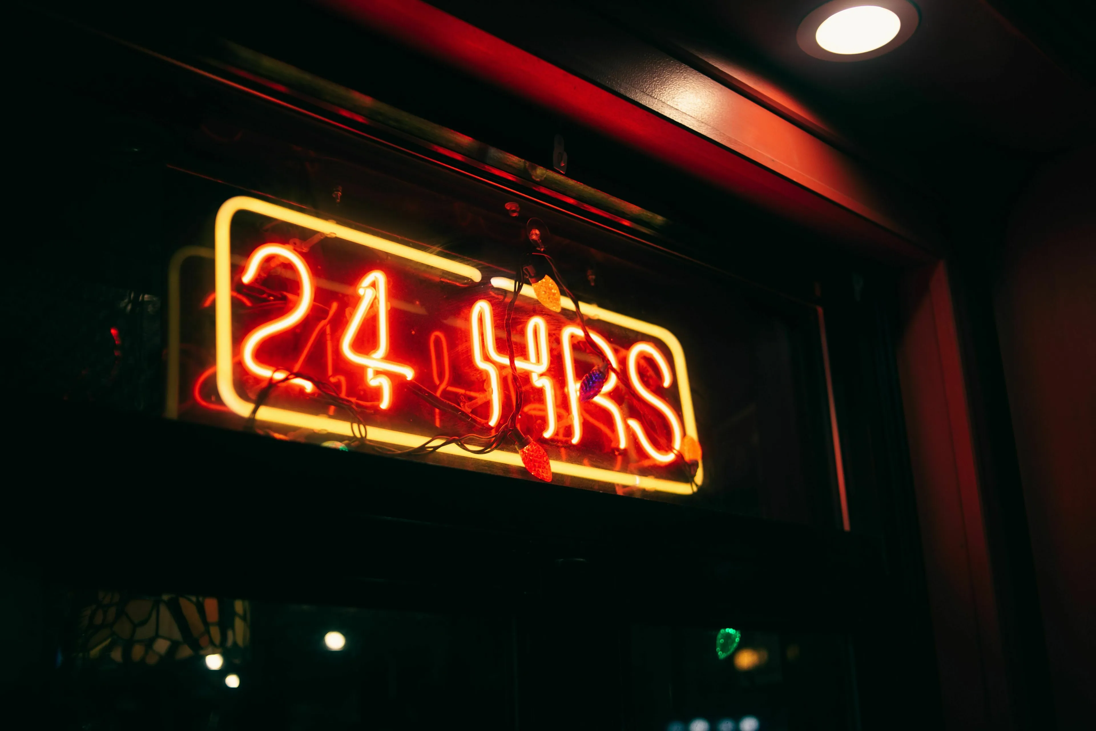 Neon sign brightly displaying 24 HRS, representing a 24-hour period for a general knowledge quiz.