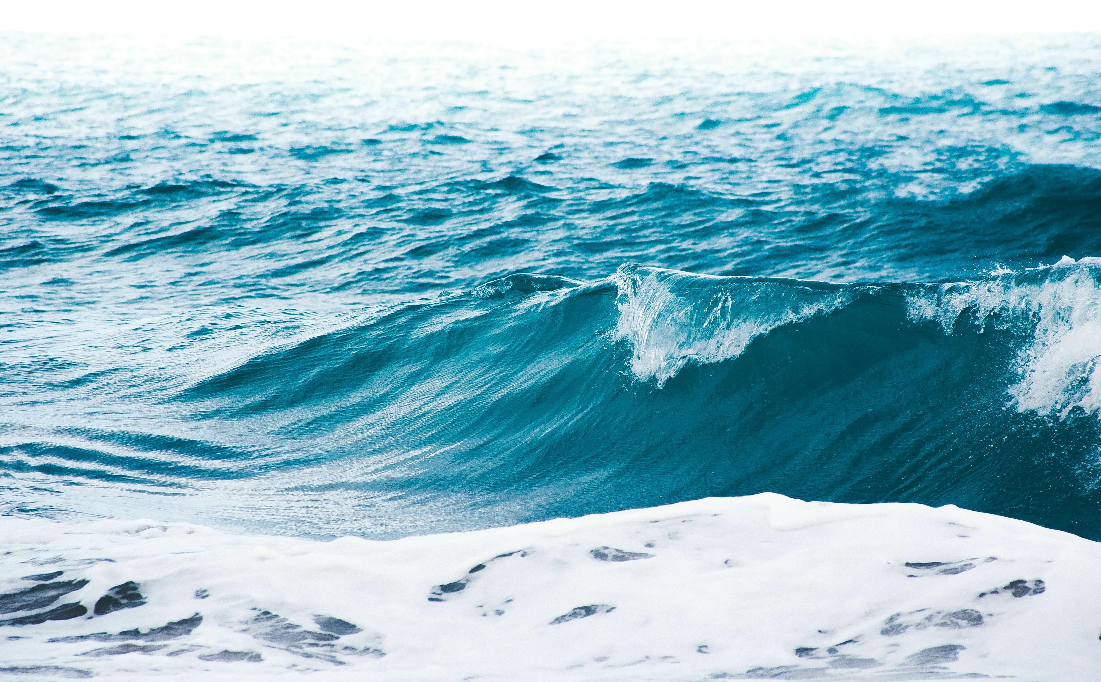 Waves breaking in a vast ocean, illustrating the term for large bodies of water for a general knowledge quiz.