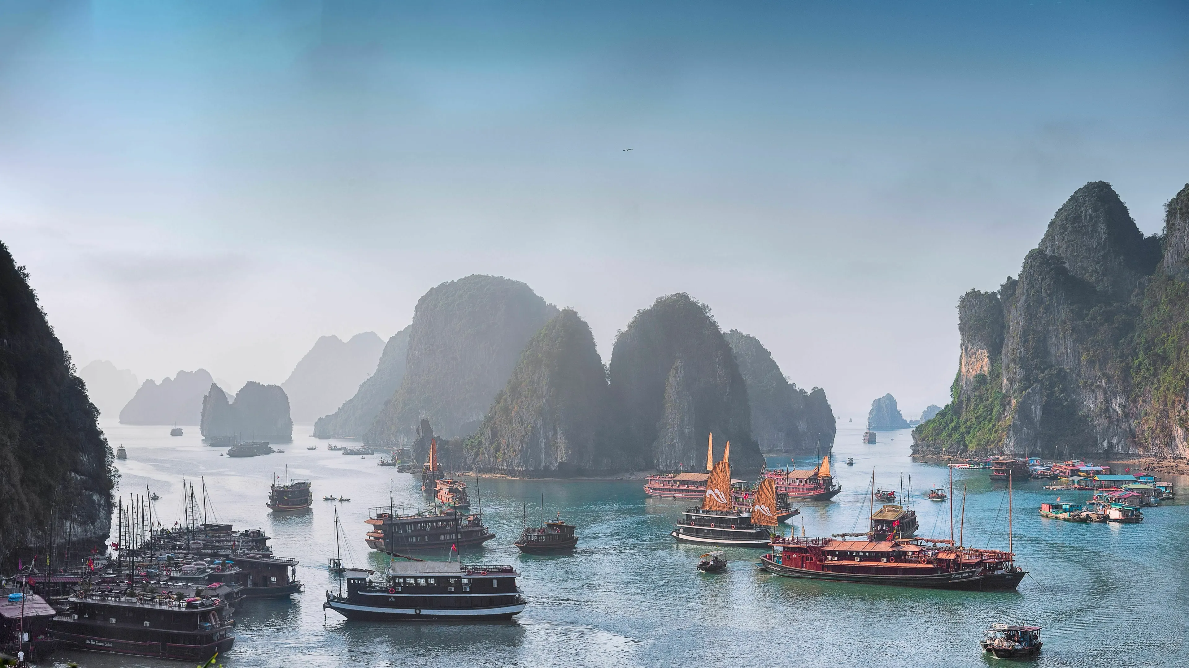 Three Letter General Knowledge Quiz: Panoramic view of a body of water partially enclosed by land, with many boats.