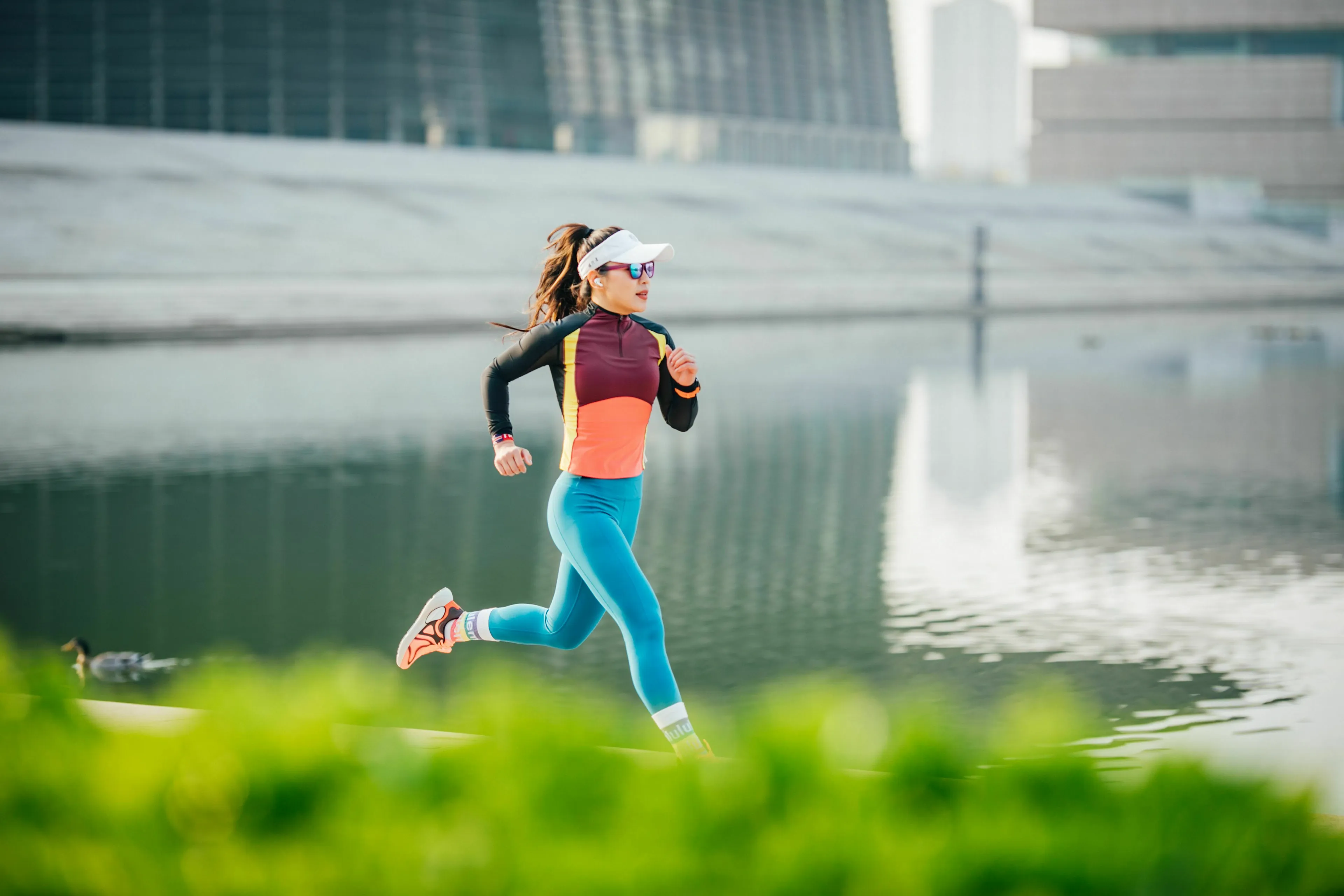 Three Letter General Knowledge Quiz: A woman running by a body of water, illustrating the past tense of run.