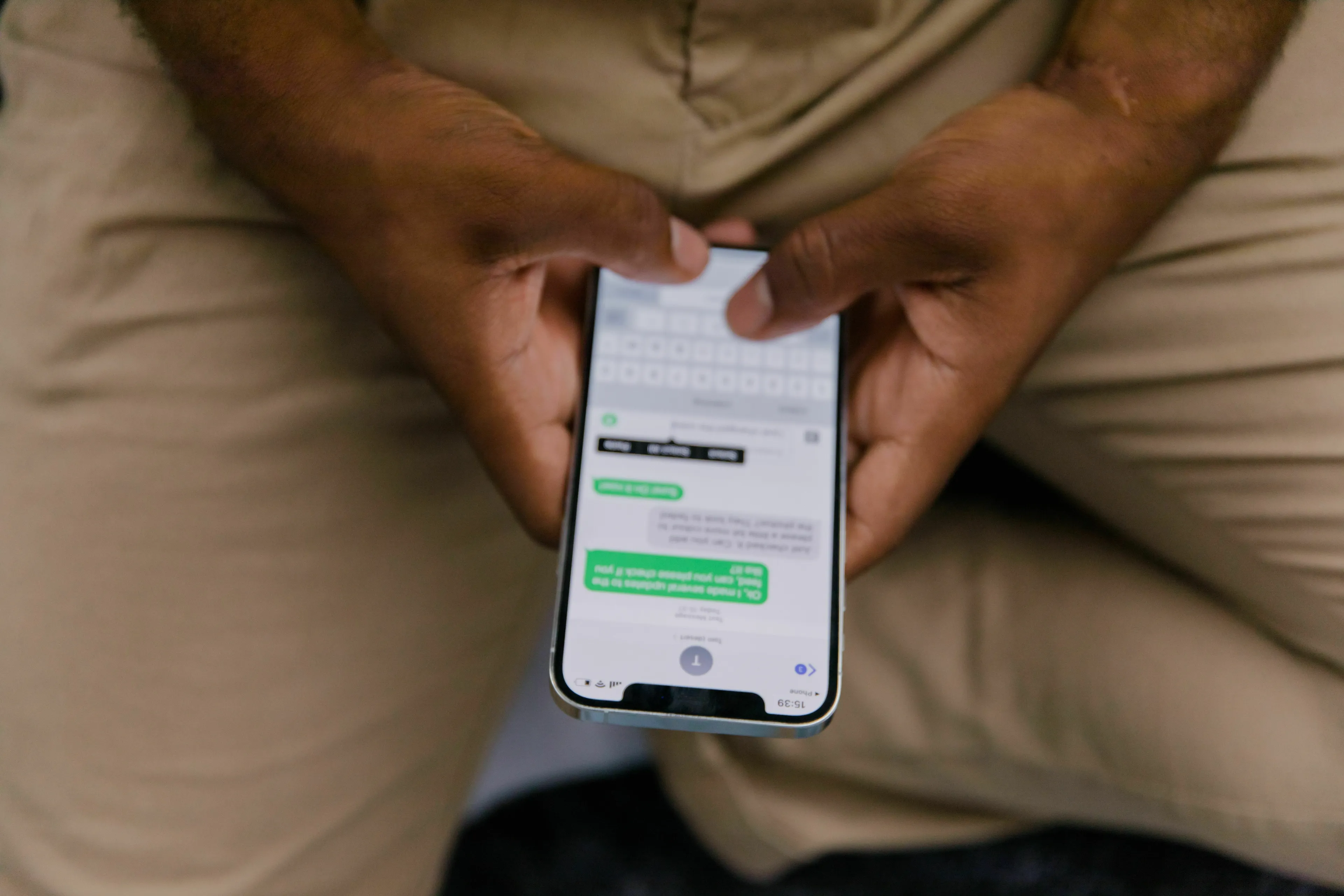 Close-up of a person holding a smartphone, typing a message, reflecting the personality of someone reacting to an article.
