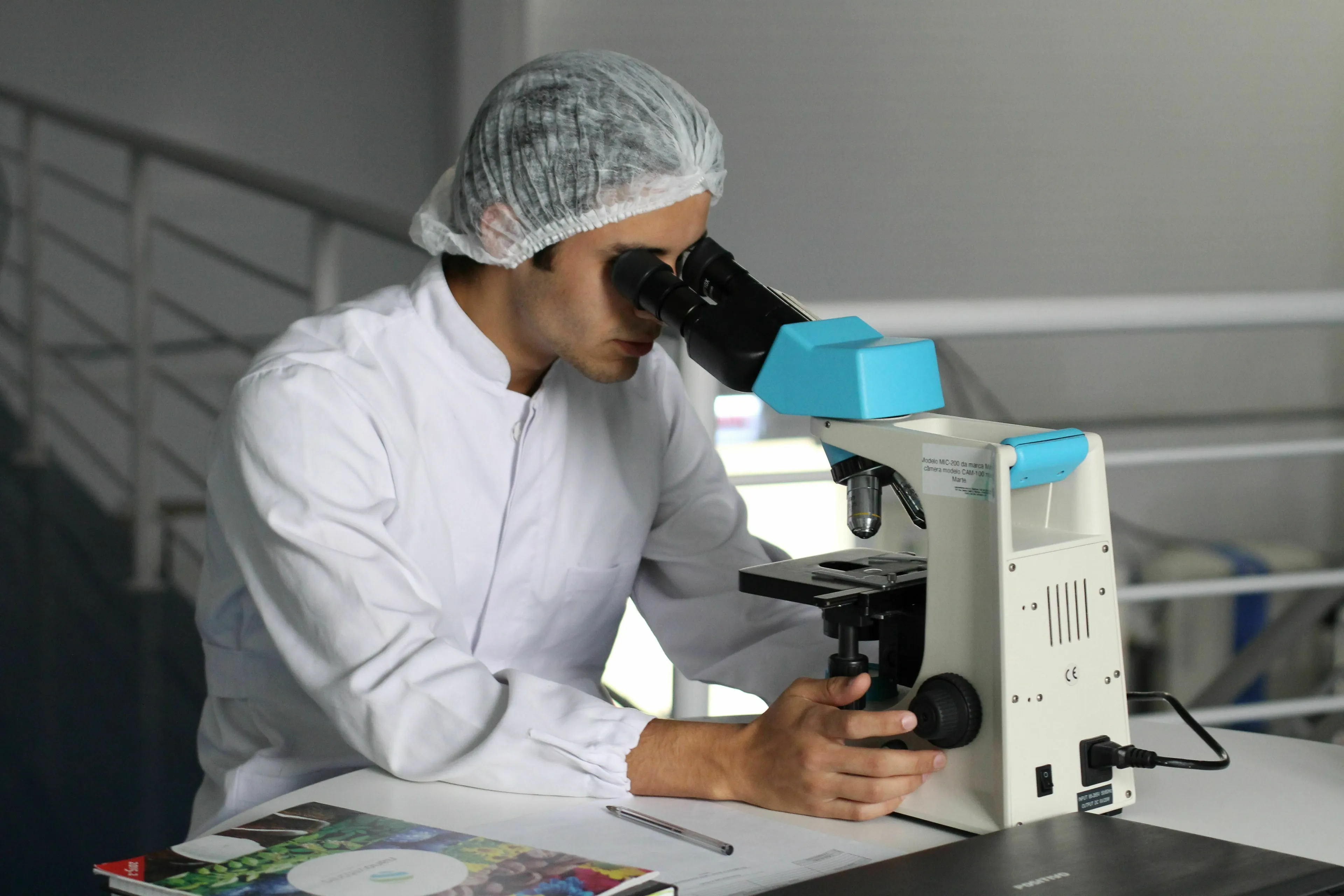 Conspiracy theory personality quiz: A scientist looking into a microscope, representing new technology and safety.