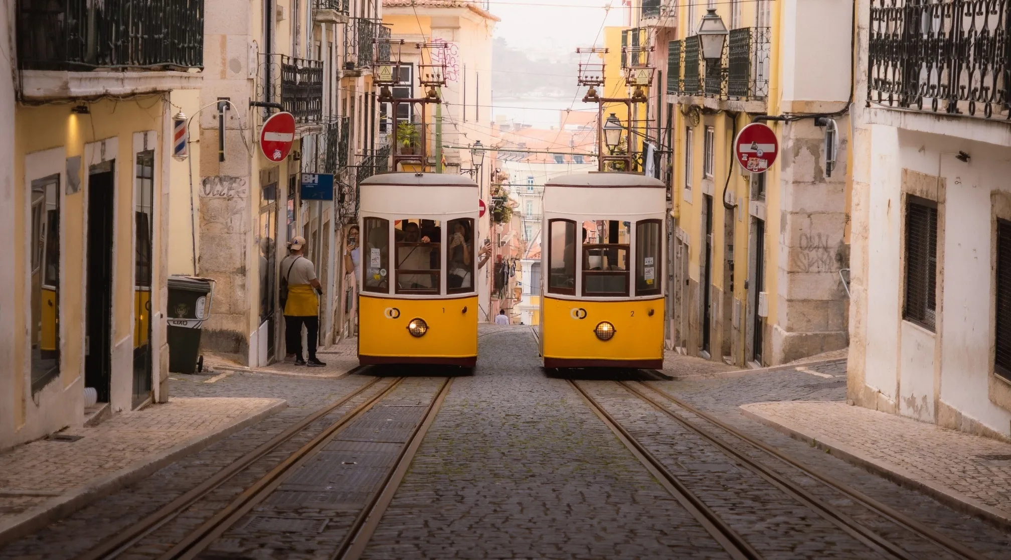 Two yellow trams on tracks in a charming European capital, surrounded by historic buildings. General Knowledge Europe.
