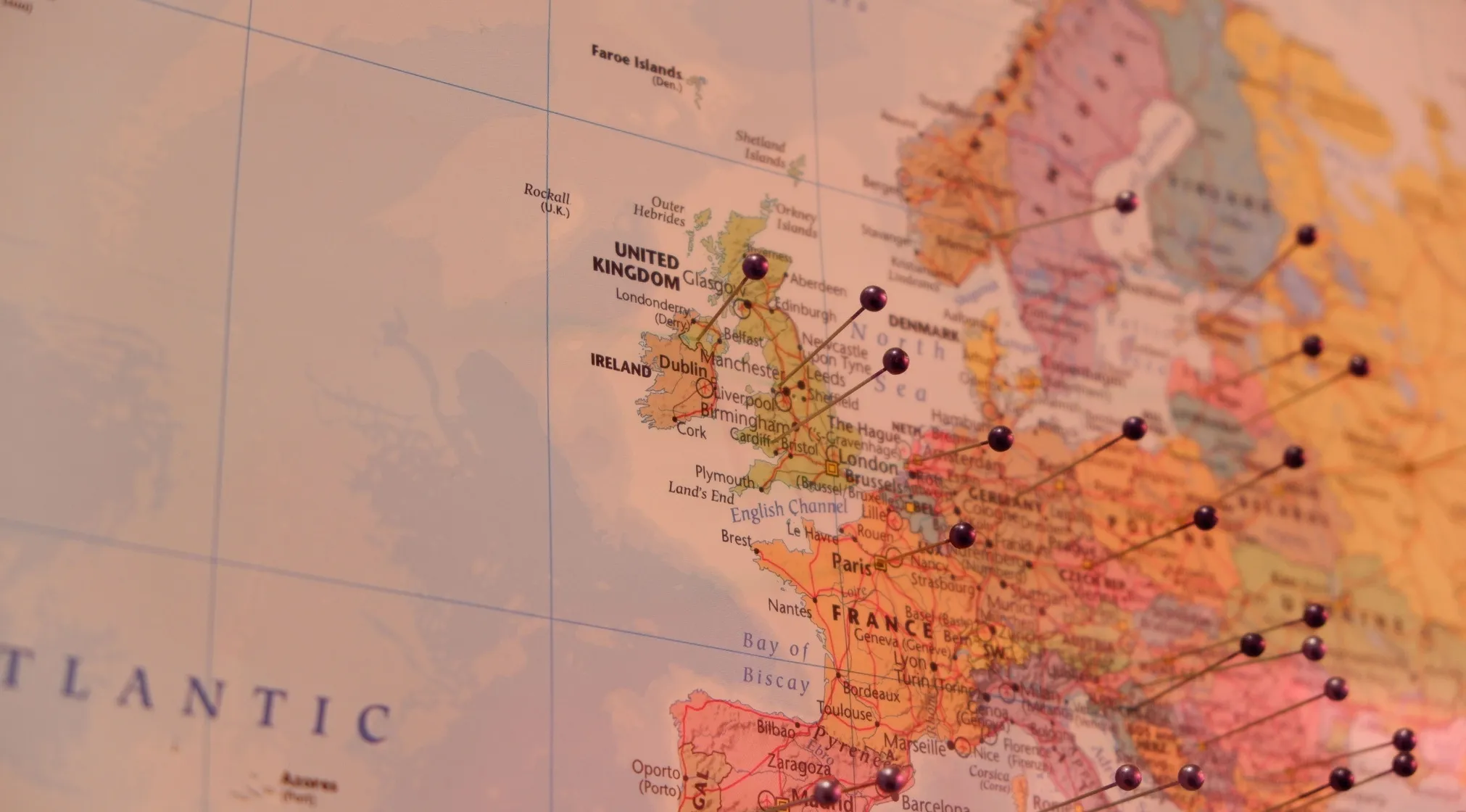 A close-up of a Europe map with pushpins marking various cities, illustrating countries in Europe.