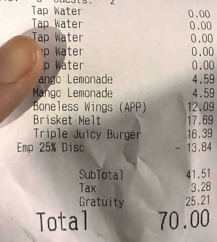 A restaurant receipt showing a significant gratuity, highlighting the impact of tipping culture in the US.