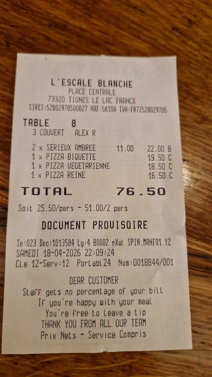 A restaurant receipt from France stating staff get no percentage of the meal and that tipping is optional, showing an alternative to US tipping culture.