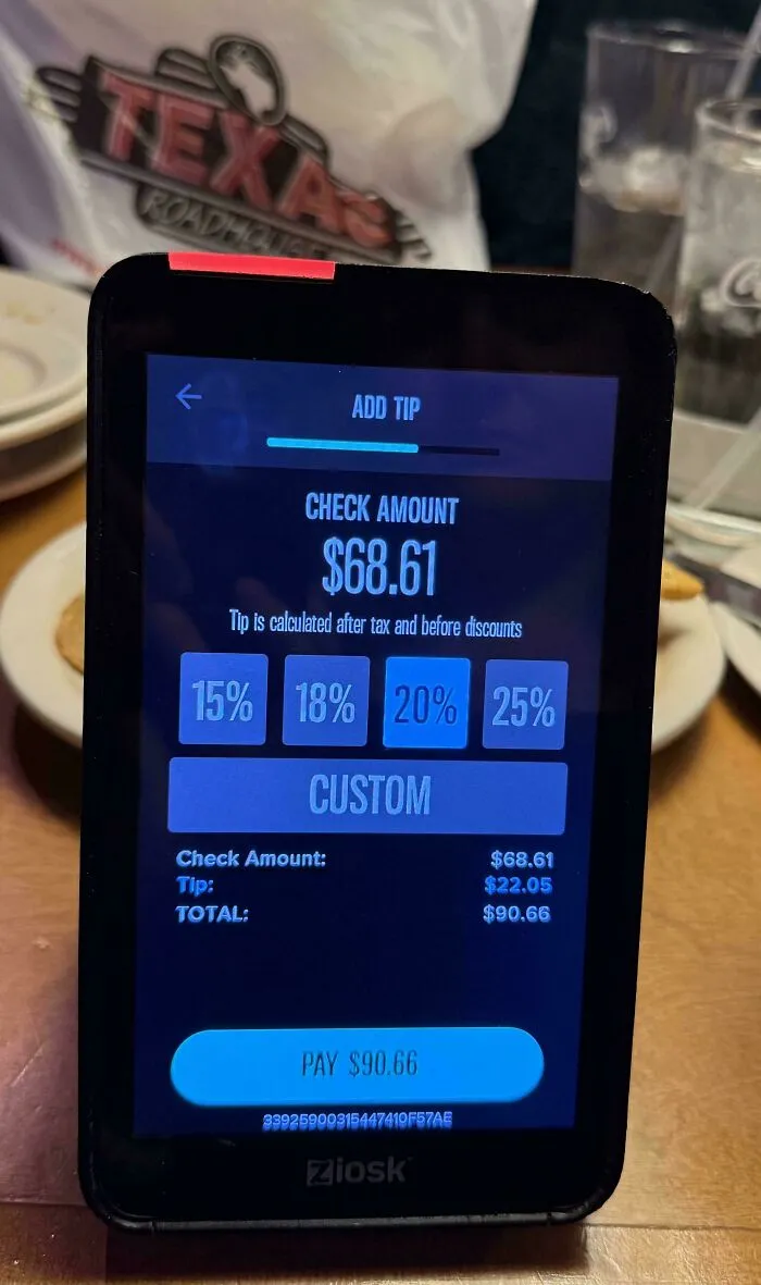 A Ziosk device showing check amount and tip options, illustrating tipping culture in the US.