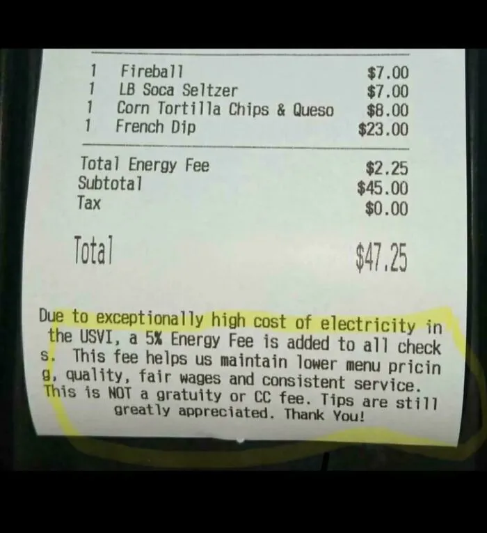 A restaurant receipt showing an added energy fee and a note explaining tipping culture is still expected.