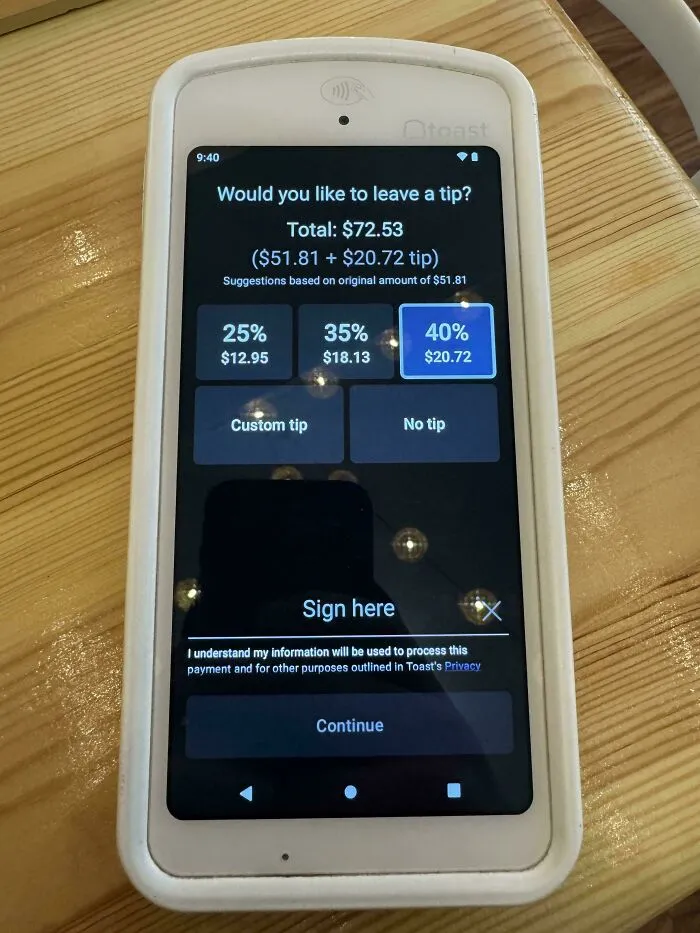 A payment terminal screen showing tipping options with a 40% tip highlighted, illustrating tipping culture.