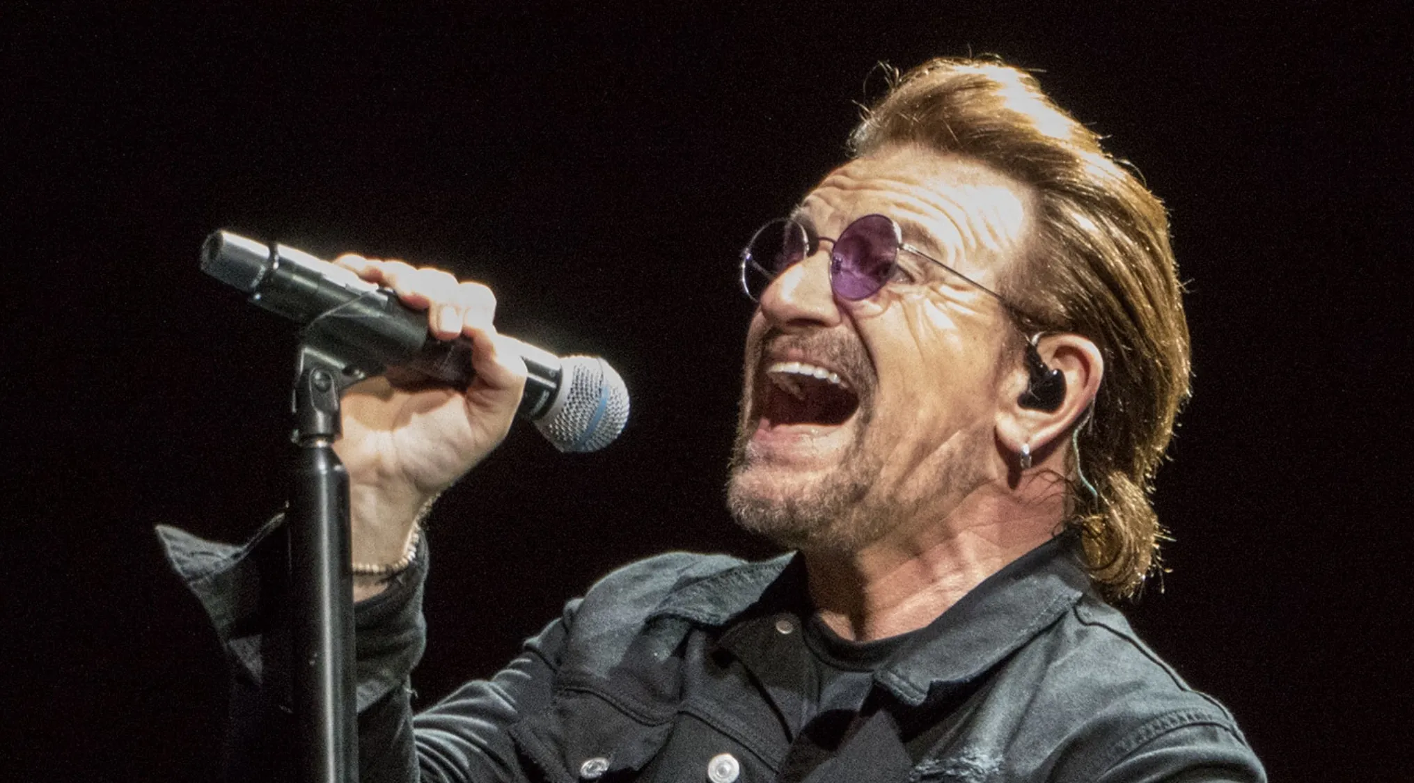 Bono, lead singer of U2, performing live, 80s-90s music from A to Z.